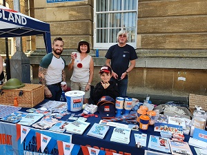 Photo of GCN Trustees Gary & Janet Murden, and GCN Volunteers Dan and Alfie Bufton on the Combat Stress information and merchandise stand